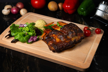 lamb ribs on dark background