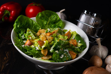 caeser salad on dark background