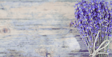 Bouquet of dried lavender on an old painted wooden background close up