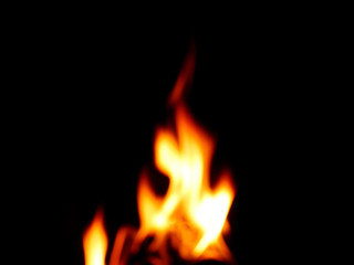 Fototapeta premium The fire that burns naturally during the night on a black background