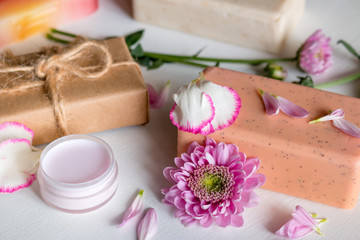 Obraz na płótnie Canvas natural handmade cosmetics. soap and spa face cream from herbs and flowers on white background