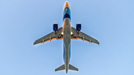 Aeroplane Photographed From Below at landing,  bottom view of the belly with the power train.
