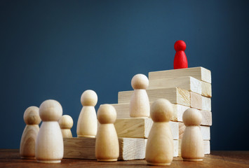 Career growth and development. Stairs from blocks and figurine as leader.
