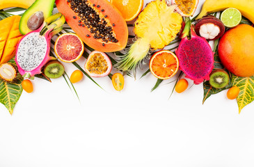 Still life with fresh assorted exotic fruits on a palm leaf.