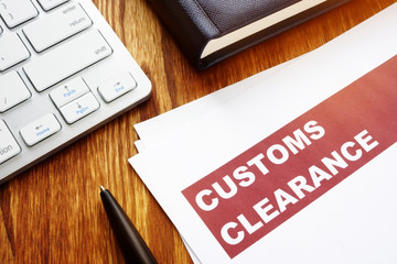 Customs clearance documents on an office table.