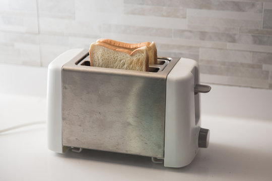 bread on toaster in the kitchen for breakfast
