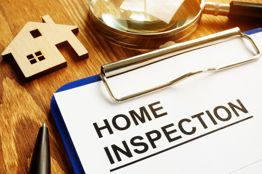 Home inspection form with clipboard and pen.