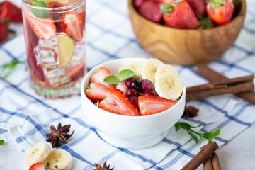 Healthy breakfast muesli with banana strawberries and berries