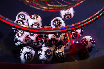 Black and white lottery balls in a machine