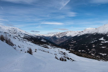 Fototapeta na wymiar Downhill slope and apres ski mountain hut with restaurant terrace in the Italian Alps, Europe, Italy. Ski area Santa Caterina Valfurva