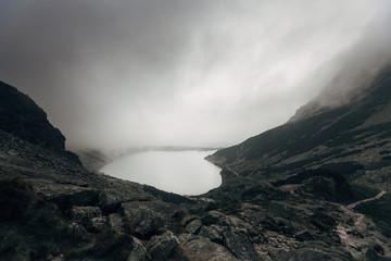 Mountain lake Czarny Staw in dramatic clouds - polish Tatra mountains