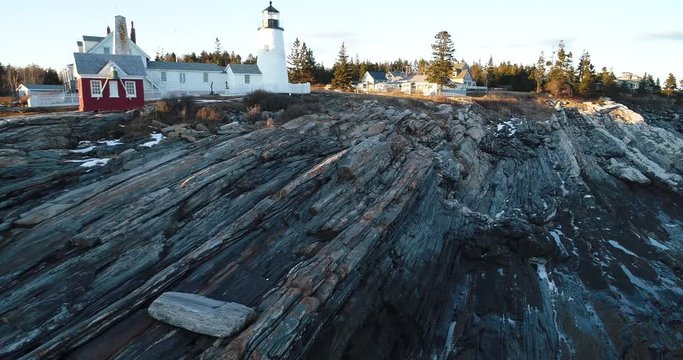 A man walking by the rocks in Curtis island lighthouse Camden Maine USA