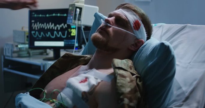 Man lying in hospital bed with head injury