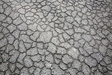 Cracked pattern of paved road for background.