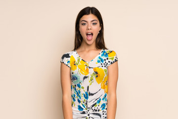 Obraz premium Teenager girl with floral dress with surprise facial expression