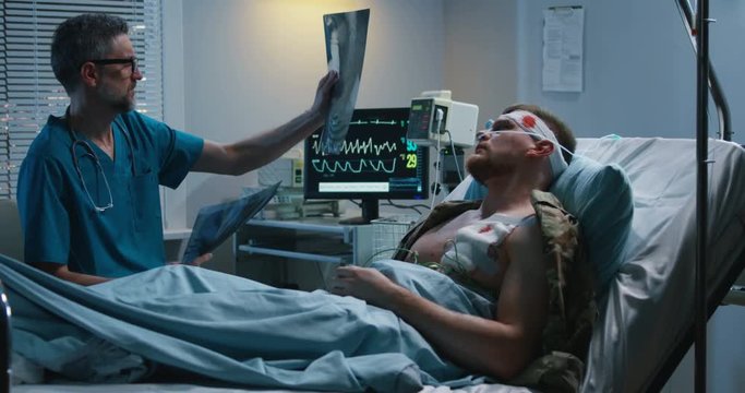 Doctor showing x ray to injured patient