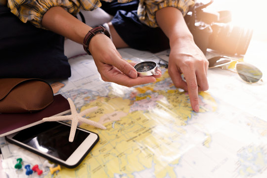 Hand to planning vacation trip and accessories for travel