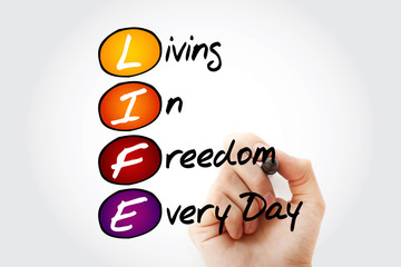 Hand writing LIFE - Living In Freedom Every Day with marker, acronym business concept