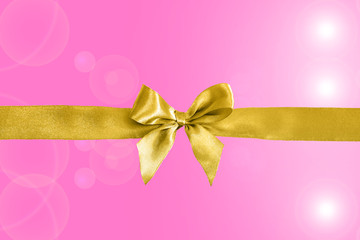 Golden ribbon with decorative bow on colorful background. Festive background.