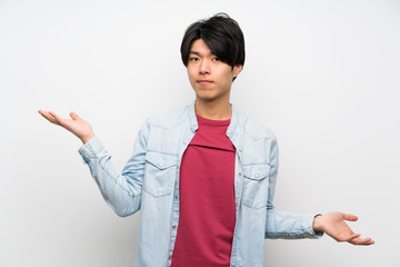 Asian man on isolated white background unhappy for not understand something