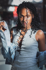 Young dark-skinned woman dressed in casual clothes in the mall