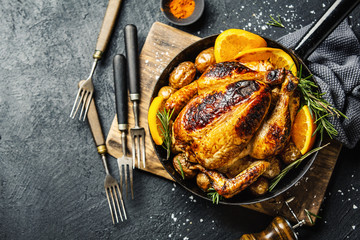 Baked whole chicken with spices on pan