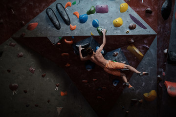 Athletic man practicing in a bouldering gym © Nejron Photo