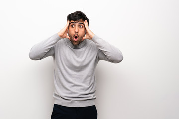 Fototapeta premium Young man over isolated white wall with surprise expression
