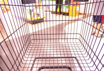 empty shopping cart in supermarket ,Supermarket interior. Blurred background .