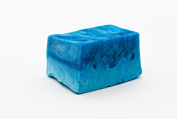 Different shades of blue natural soap bar piece on white limbo background