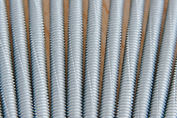 Screws photo background. Metal screws are used to fasten insulation panels to the metal frame of a new building.