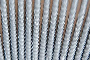 Screws macro photo. Metal screws are used to fasten insulation panels to the metal frame of a new building.