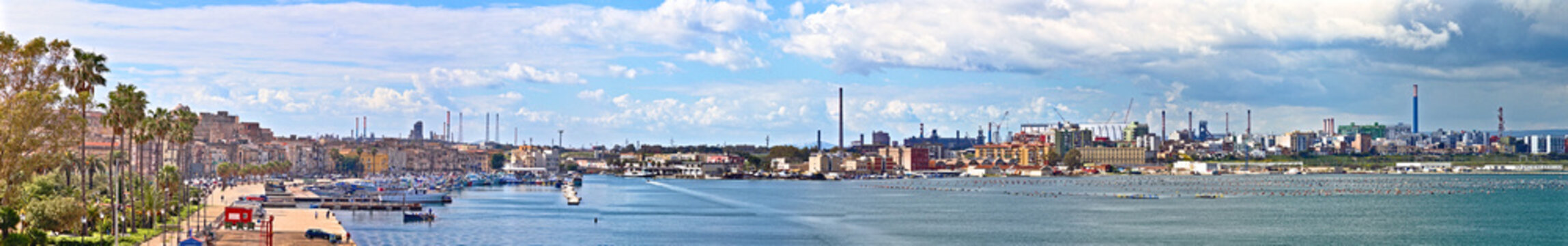 Panoramic view of the Taranto old town and industrial area which includes a petroleum product refinery and a steel industry. Puglia, Italy