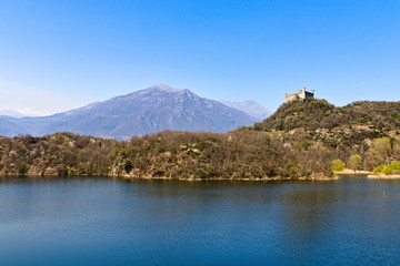 Naklejka na ściany i meble The castle of Montalto Dora, at an altitude of 405 meters, on the Pistono Lake, in the morainic amphitheater of Ivrea, dating back to the mid-12th century. Clear sunny spring morning