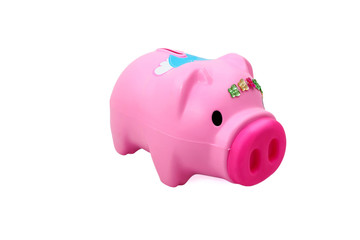 A pink pig plastic coin bank isolated white at the studio.