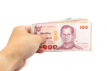 Hand holding thai money on white background.