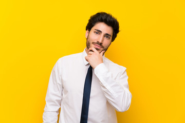 Businessman on isolated yellow background laughing