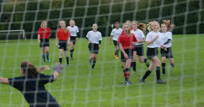 4K Disappointed goalie fails to make a save at girls' football match. Slow motion.