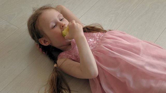 little girl eating an apple