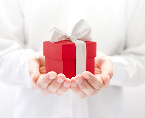 Small red present box in hands 