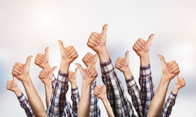 Row of man hands showing thumb up gesture