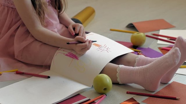 little girl draws with pencils, children's creativity, development