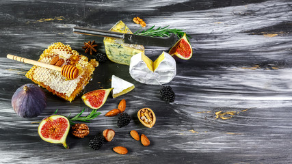 cheese platter, figs and honey, snacks, on old wooden table. top view. copy space