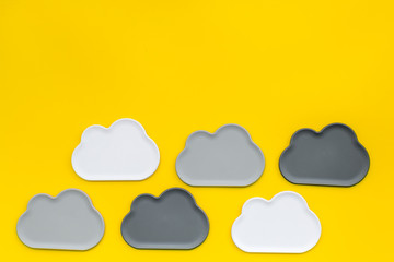 Clouds figures for cloud storage on yellow background top view mockup
