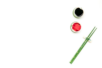 bamboo sticks, soy sauce, ginger for sushi and maki on white background top view mockup