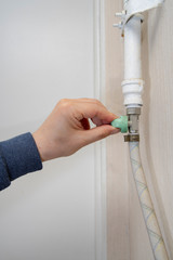 Man's hand to open and close the gas valve.