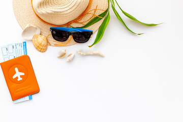 Summer travaling to the sea with straw hat, sun glasses, tickets and passport on white background top view mock up