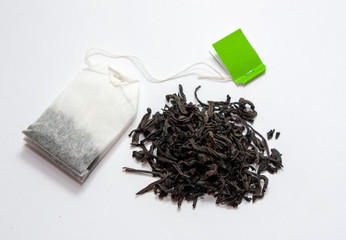 Tea bag with green label. Large leaf tea. View from above. On a gray background