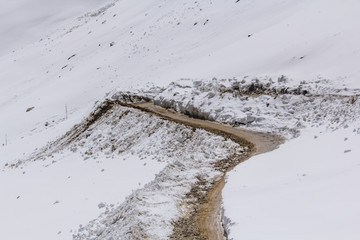 Scenic view between path on Khardung La, mountain pass in the Ladakh region of Jammu and Kashmir, India.