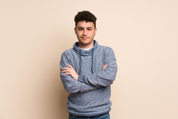 Young man over isolated wall feeling upset